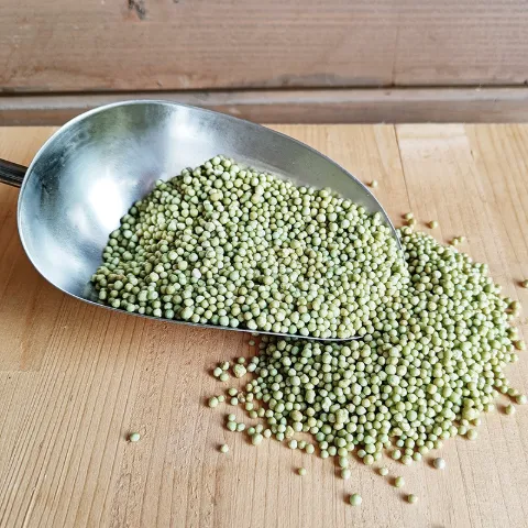 A scoop of fertilizer granules